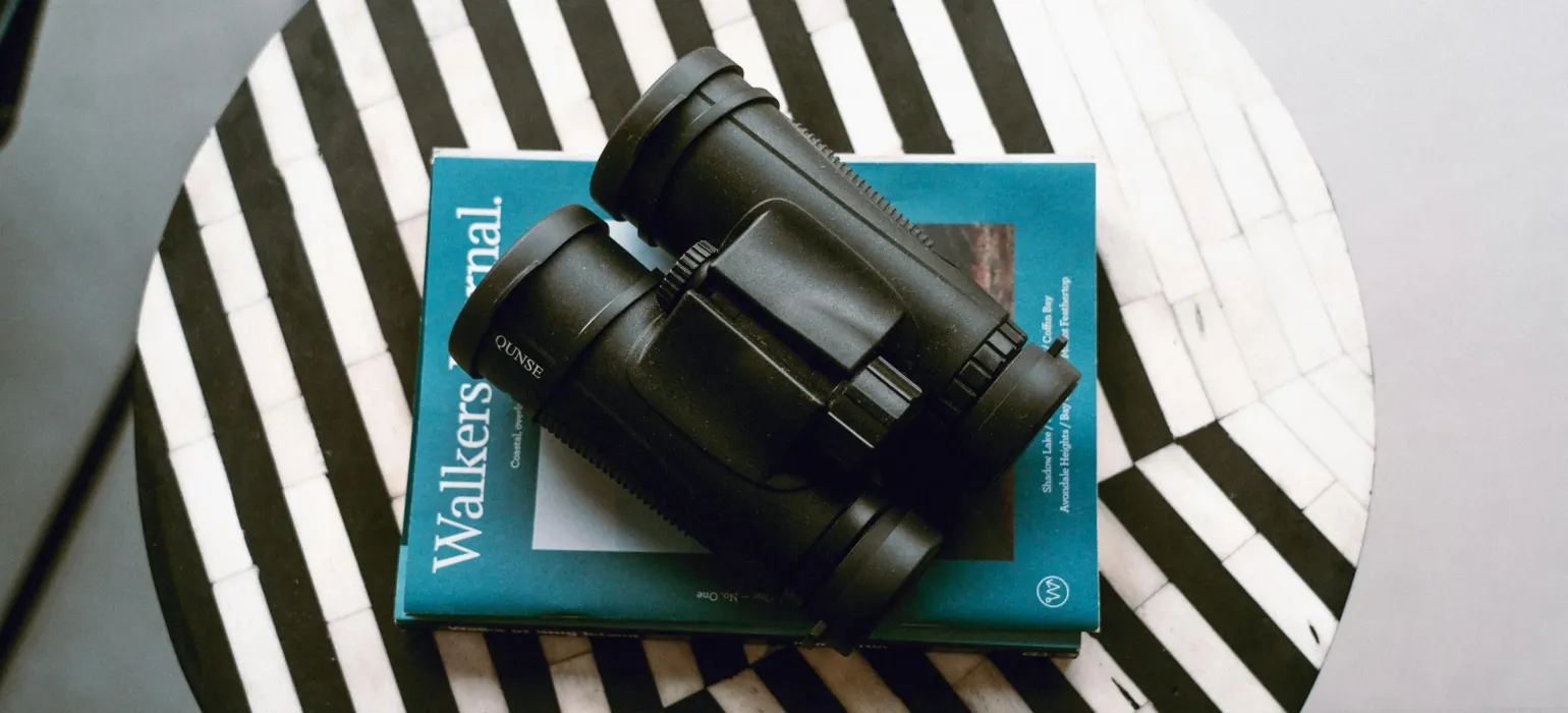 A black watch on a white and blue striped surface
