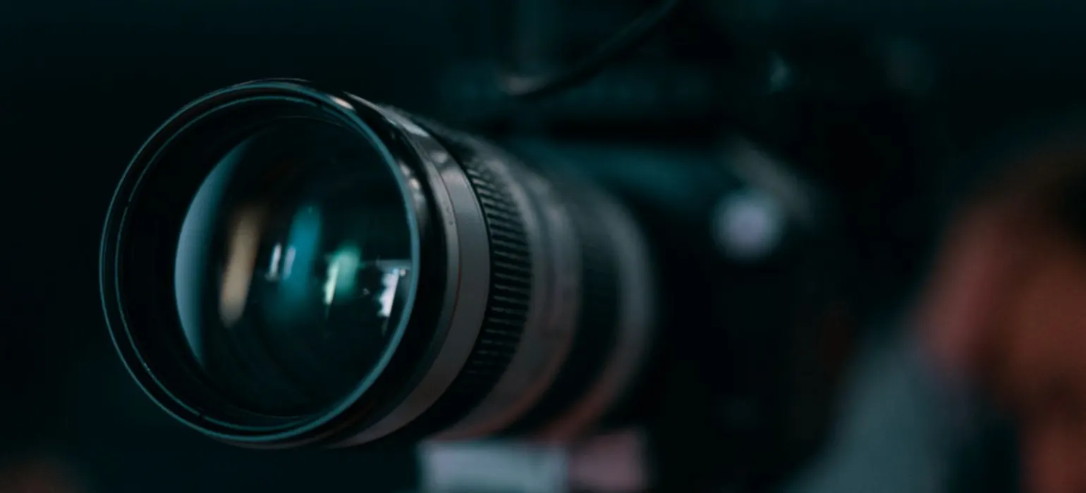 Close-up of a camera lens in low light