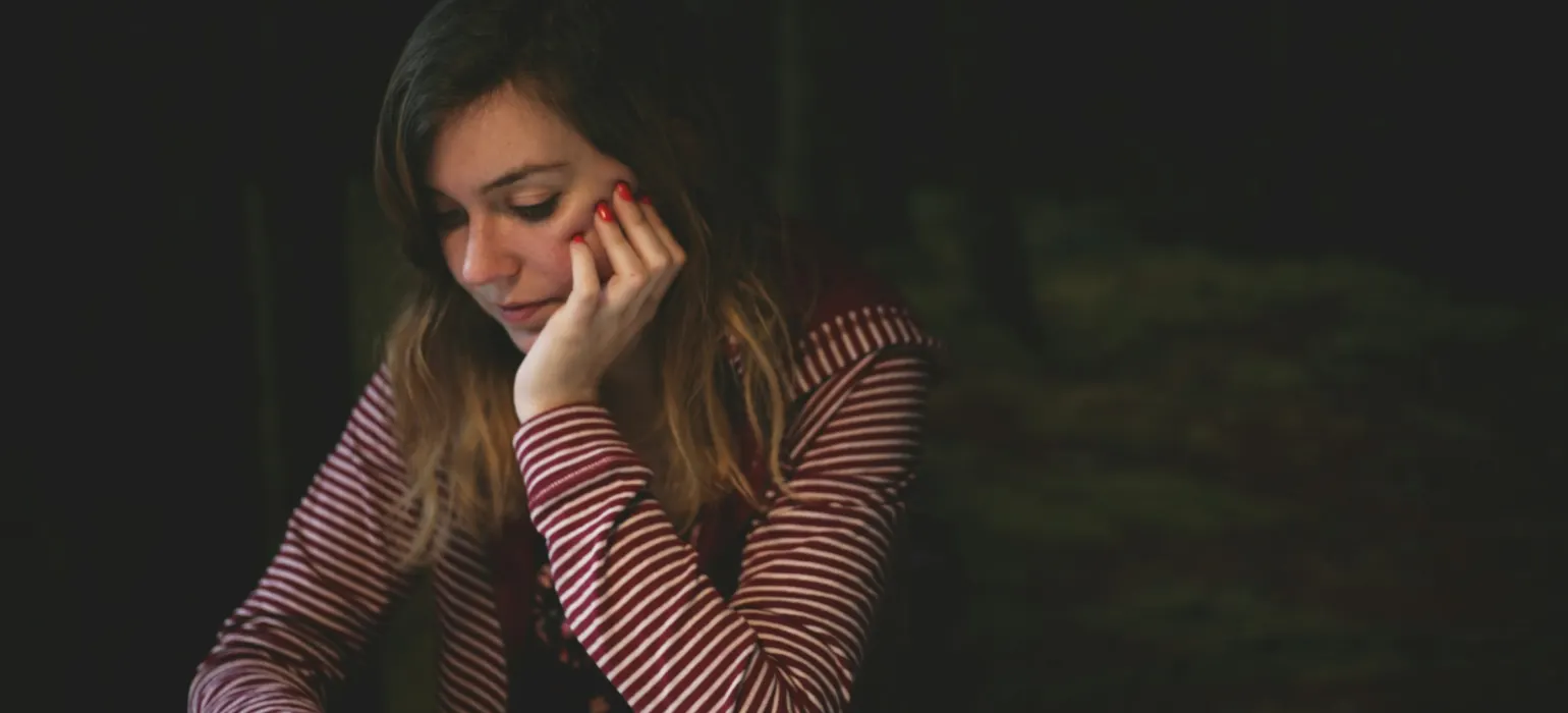 Worried woman looking at her phone